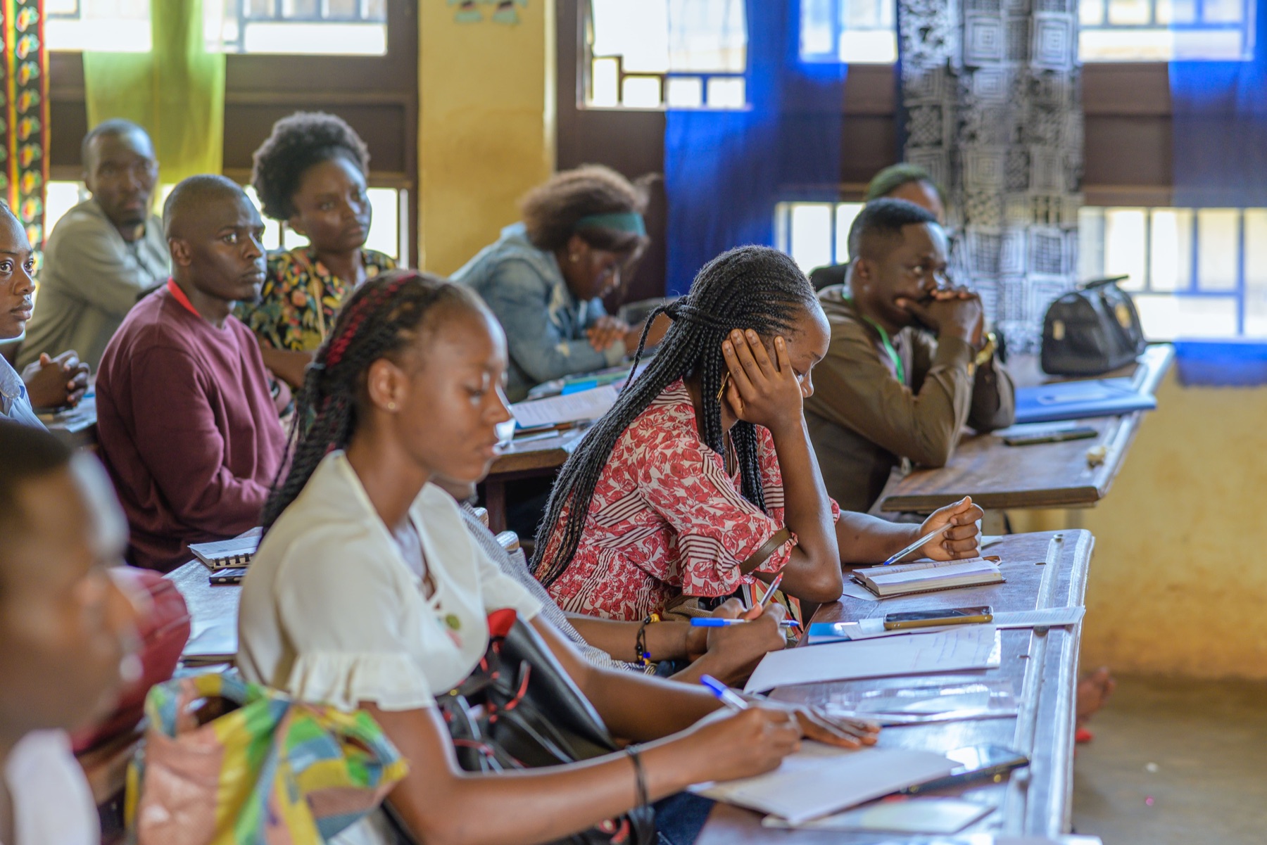 Teachers taking notes during a training session in a classroom